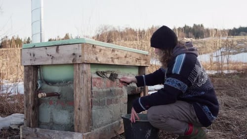 Young Adult Builds Outdoor Bathtub in Rural Setting