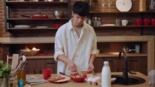 Young Adult Preparing Food in Home Kitchen