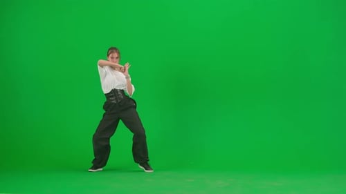 In the Frame on a Green Background Chromakey A Young Slender Beautiful Girl is Dancing She