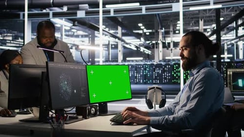 Engineer Using Green Screen Mockup PC in Data Center to Update Servers