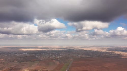 Beautiful Vista of the Hilly Landscape Above a Town Below Foggy Skyline