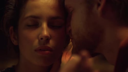 Intimate couple embracing in warm, close embrace