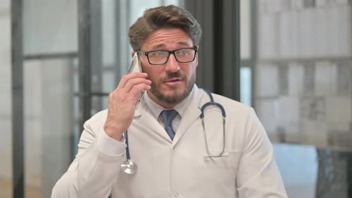 Doctor Talking on Smartphone in Office Setting