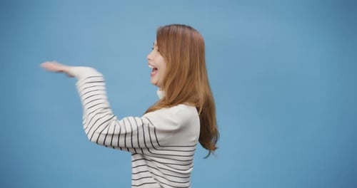 lady wear sweater enjoy happy funny dance looking at camera and move around stand isolated.