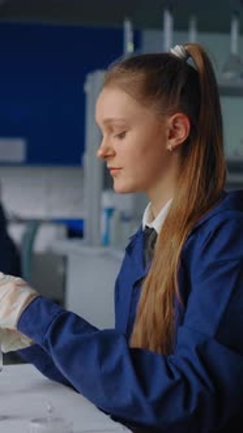 Teenage Girl Scientist Mixing Chemicals in Test Tube