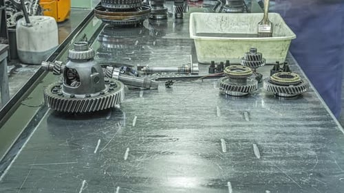 Assembly of a gearbox at a mechanic's garage and workbench - time lapse