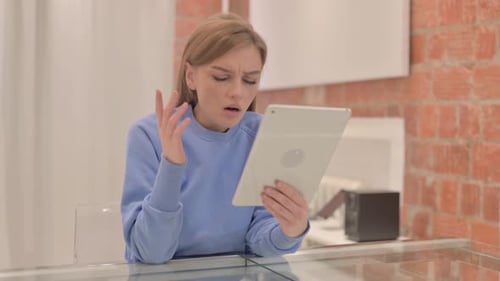 Frustrated Woman Using Tablet Device at Home