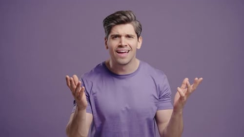 Man Expressing Confusion and Frustration Against Purple Background