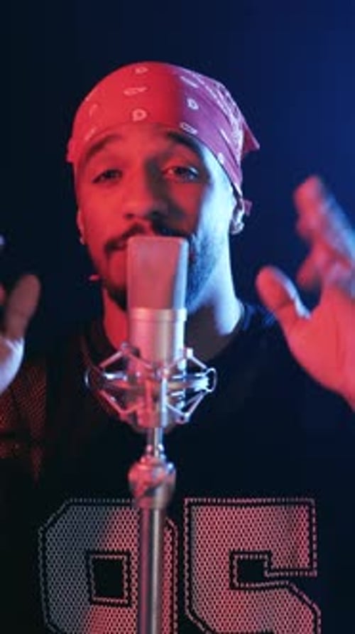 Young Male Rapper Singing Into a Professional Microphone Vertical
