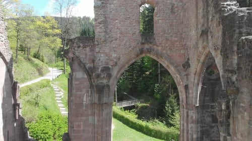 Rising pedestal drone view of monastery ruins set within beautiful wooded area, (Black Forest, Germa
