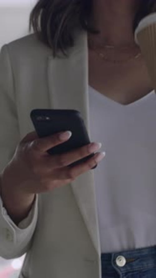 Woman in Blazer Using Smartphone in Urban Setting