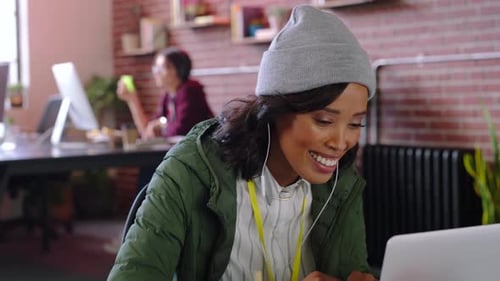Woman Discusses Documents While Working on Laptop