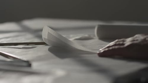 A person paging through pieces of paper