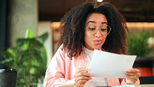 Excited African American Woman Reacts Happily to Surprising Good News in Office