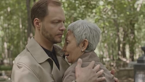 Loving Man Comforting Senior Woman in Nature