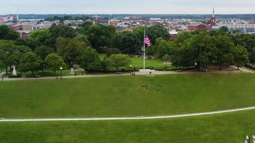 Aerial View of City Park with American Flag