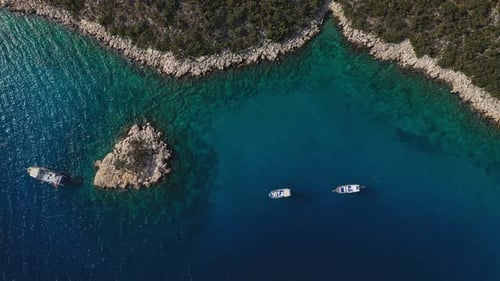 Sailing Boats Gliding Along the Scenic Island Coastline