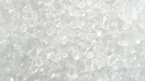 Camera focuses in on a mound of white sugar, Macro video