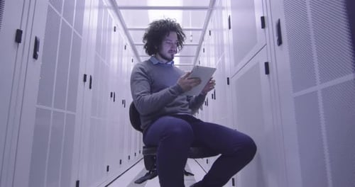 Man Working on Tablet in Server Room