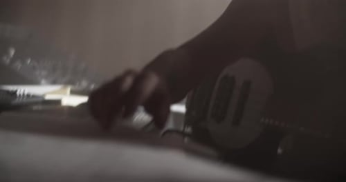 Adult Composer Reading Music Sheets in Sound Studio