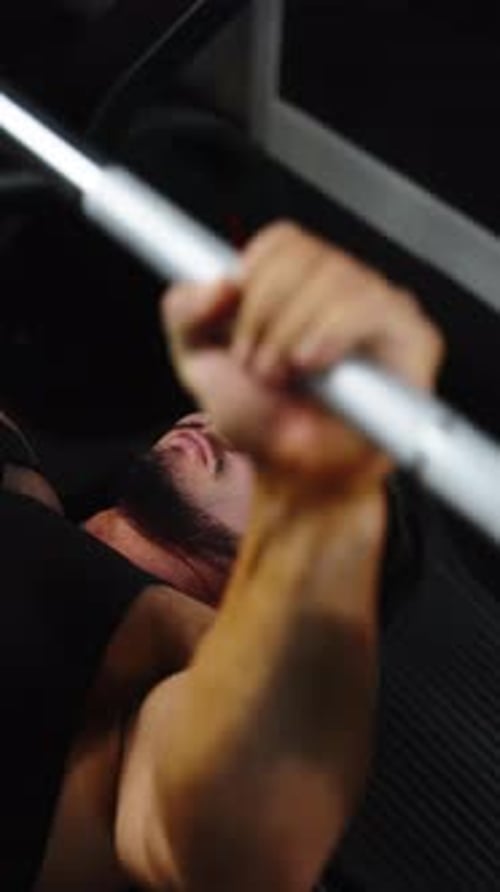 Two Frames Capture a Focused Athlete Performing a Barbell Bench Press in a Gym Closeups Highlighting