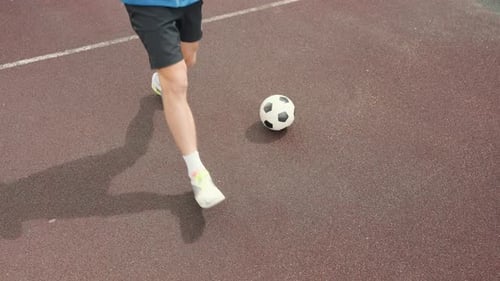 Man in Shorts Doing Leg Stretches on Court