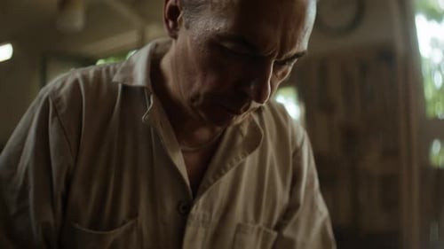 Old Craftsman Checks Polishing Machine in Woodwork Shop Closeup