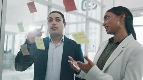 Teamwork, glass wall and business people planning, strategy and schedule in office