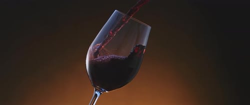 Pouring Red Wine Into Glass in Slow Motion