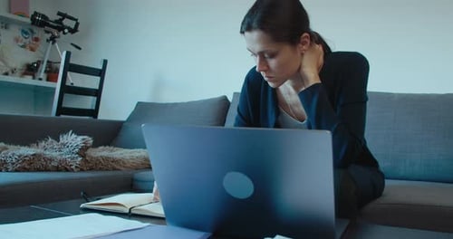 Freelance Business Woman Work at Home Using Laptop Computer and Write Notes