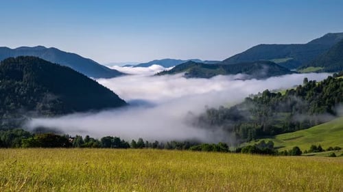 Foggy Clouds Flowing Through Mountain Valley