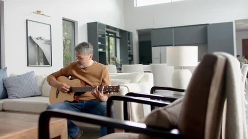 Man Plays Guitar in Modern Living Room