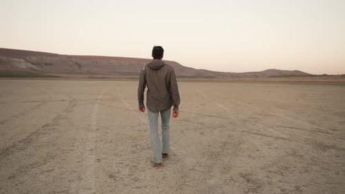 A Man Walks on a Dry Lake