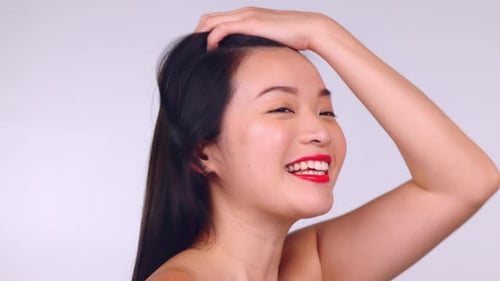 Asian, woman and face in studio for makeup, hair and skincare cosmetics by background for wellness