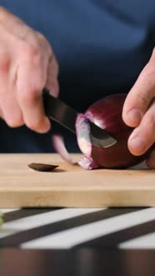 Cutting Red Onion on Kitchen Board Closeup