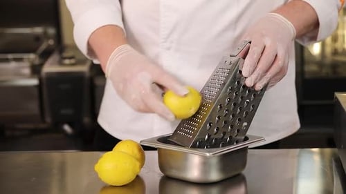 Chef Grates Lemon with Box Grater Close Up