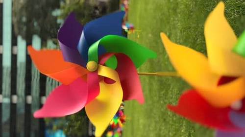 Colorful Rainbow Pinwheels Spinning in Green Field
