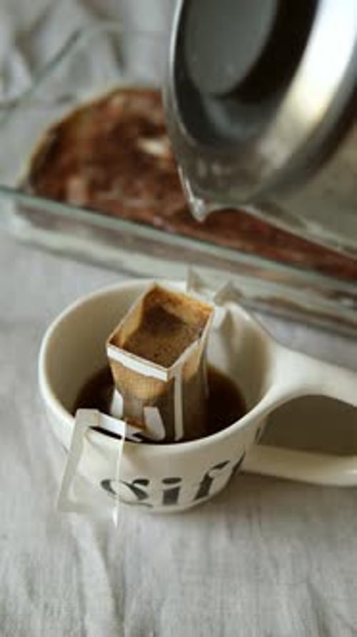 Pouring Hot Water on Teabag in Mug