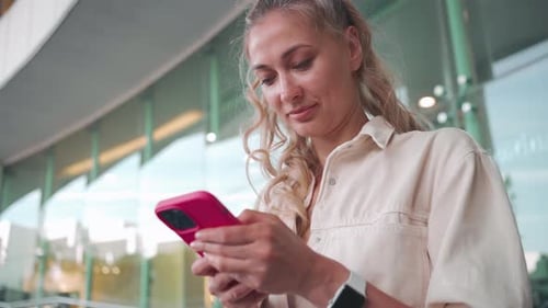 Attractive Woman Using Cell Phone in City Business District