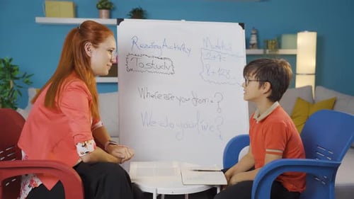 Teacher Helping Child With Math and Reading