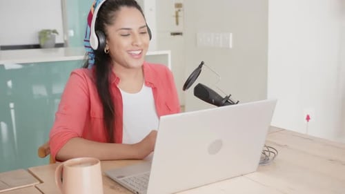 Recording Podcast Asian Woman Using Laptop And Microphone, wearing headphones