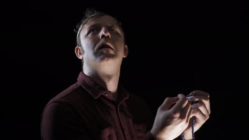 Man Holding Prayer Beads