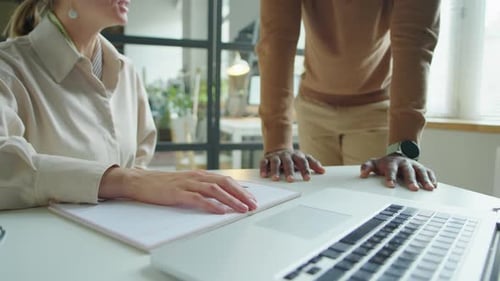Businesswoman Shaking Hands with Colleague in Office