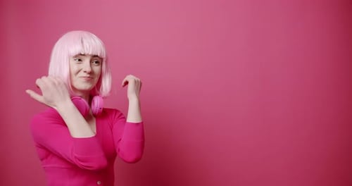 Woman with Pink Haircut Gesturing in Front of Pink