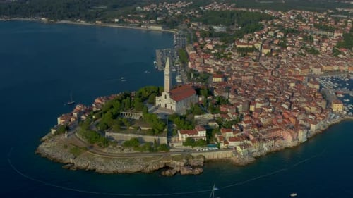 Pull in, tilt down aerial shot of the majestic St. Euphemia's Basilica in Rovinj, Croatia