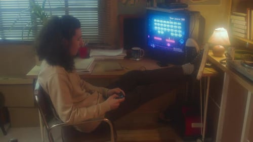 Teen Playing Retro Style Video Game Indoors