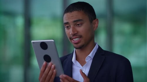A Young Professional Engaged in Utilizing a Tablet Within a Contemporary Work Environment