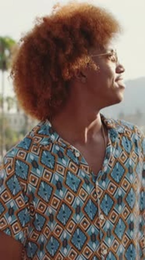 Happy guy walking in city down street