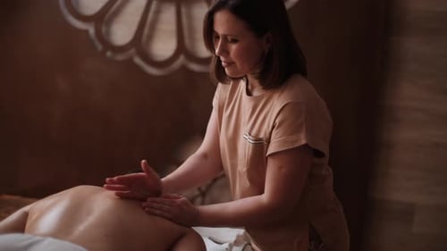 Woman Massaging Man Shoulders for Relaxation Indoors