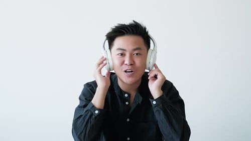 Young Adult Man Talking with Headphones On